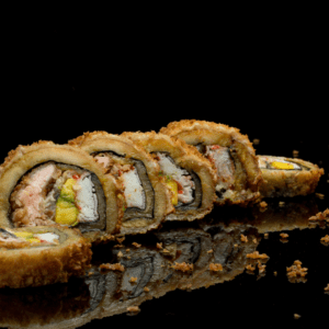 Un rollo de sushi con camarones, queso crema y cebollín, tempura. Los camarones son rosados y brillantes, el queso crema es blanco y cremoso, el cebollín es verde y fresco, y la tempura es dorada y crujiente.